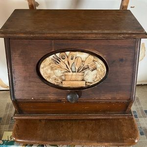 Vintage wooden bread box featuring kitchen utensil collage